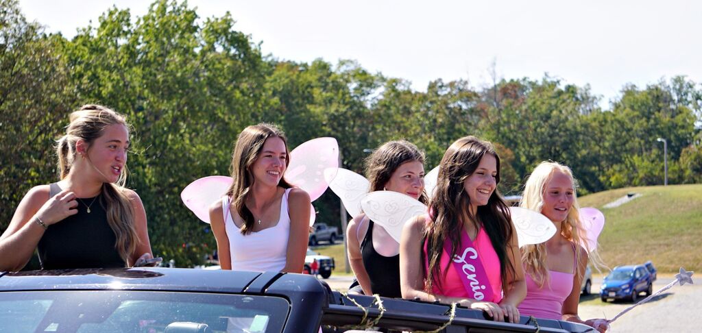 Tennis players smile from their float