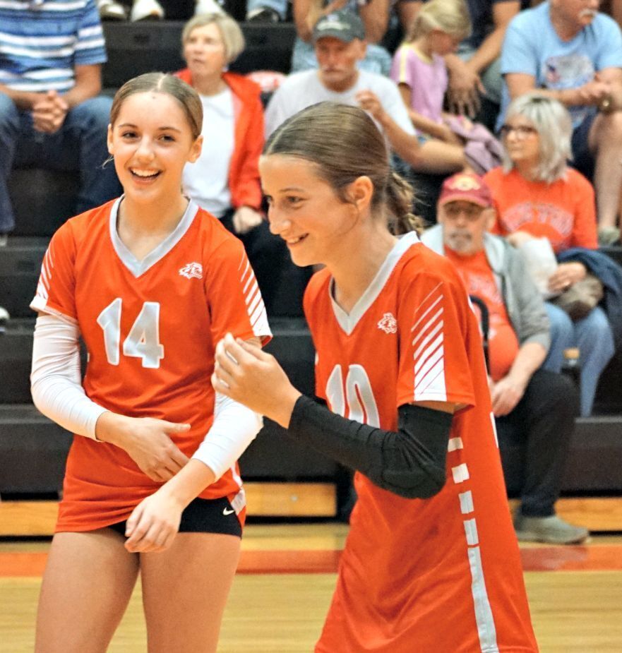 Two players smile at each other