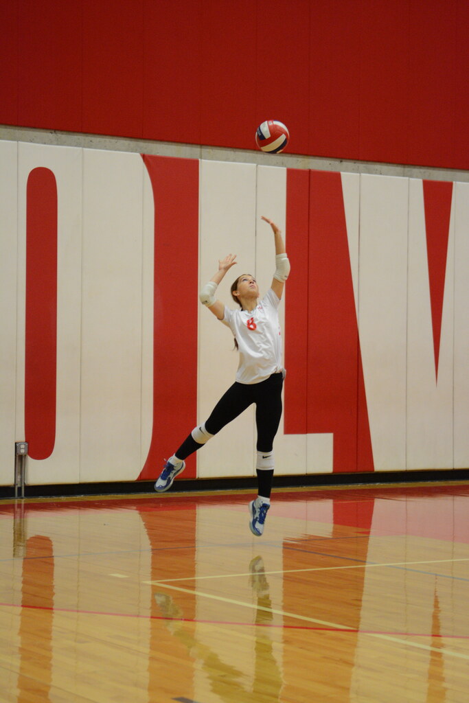Volleyball player executes a jump serve