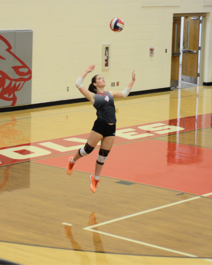 Stephanie serving the volleyball