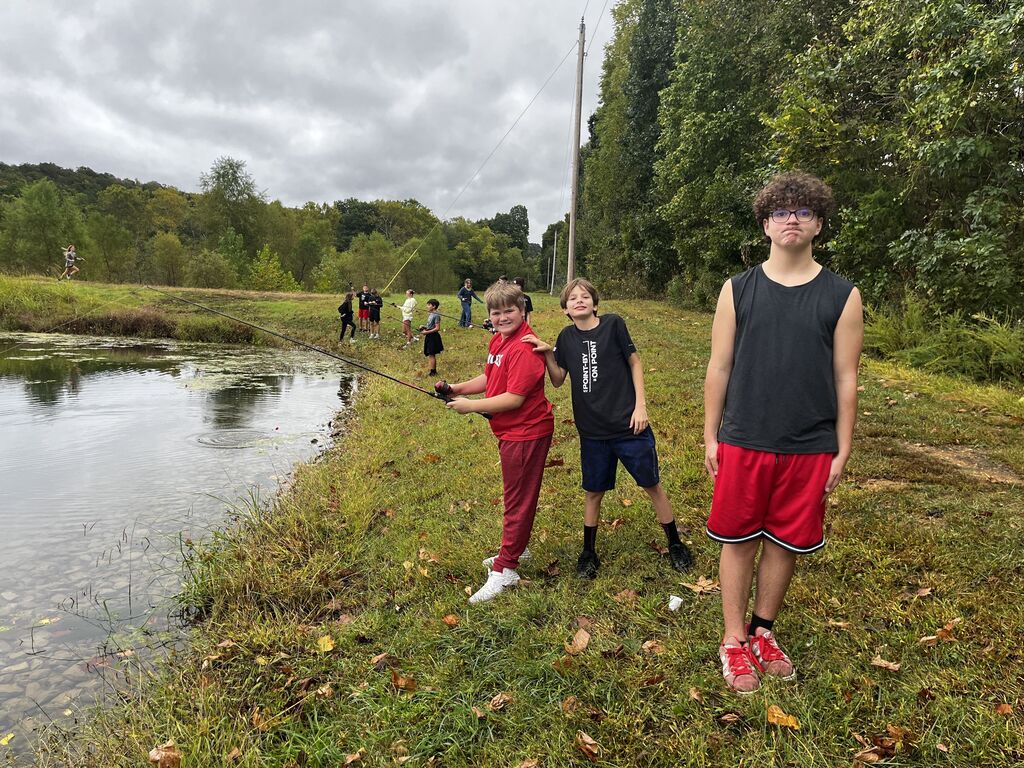 Two boys smile while fishing