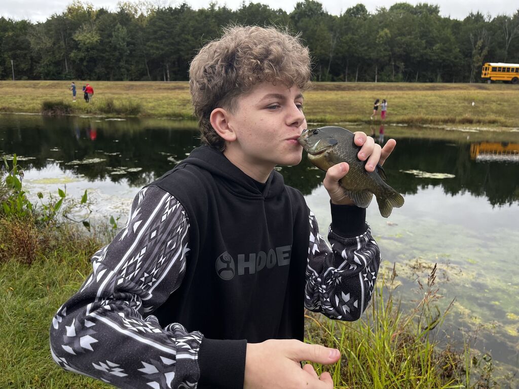 Boy kisses a fish!