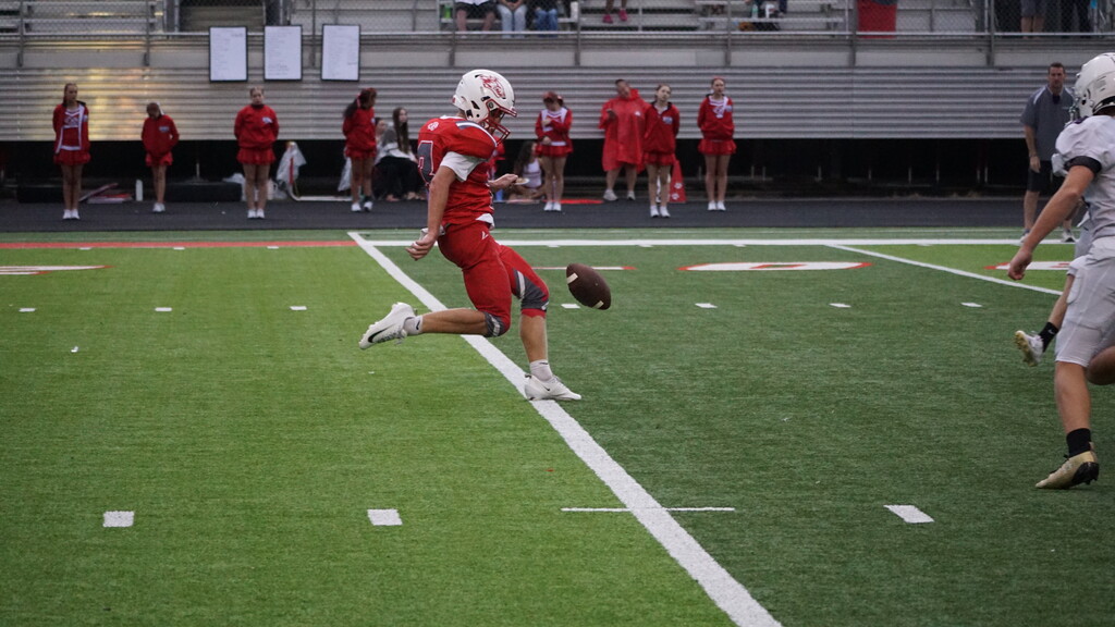 Punter kicks the ball.