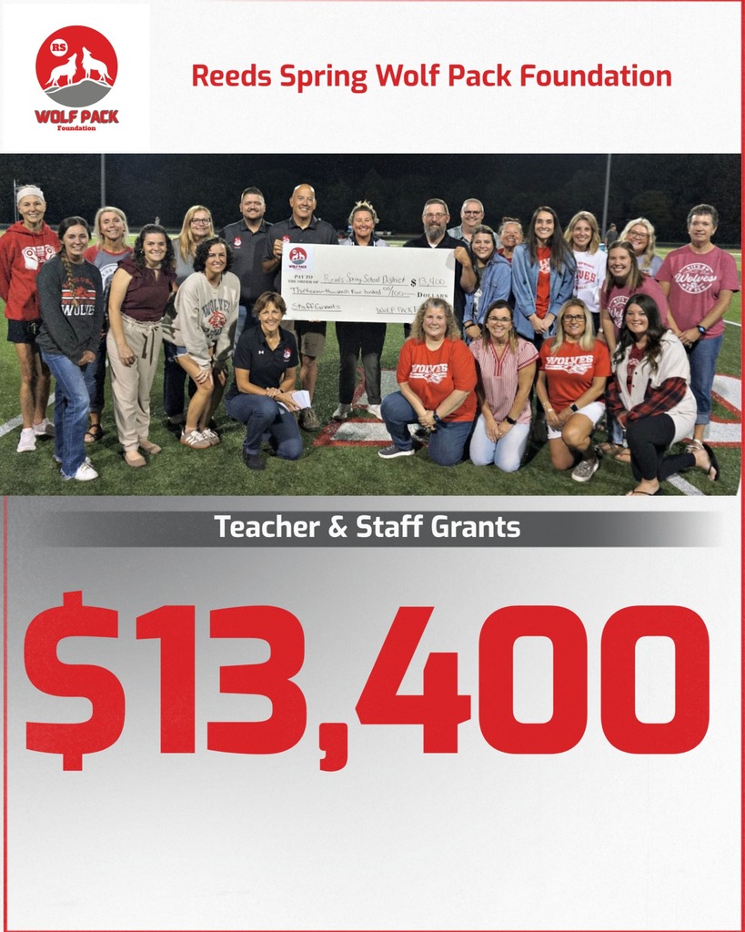 Teachers and Foundation members holding a big check