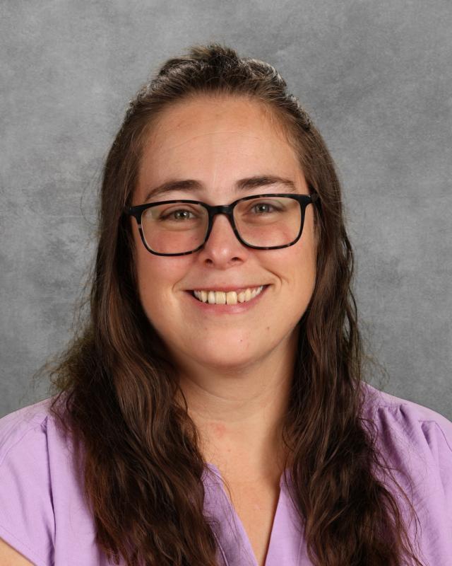 Woman with glasses smiling at camera