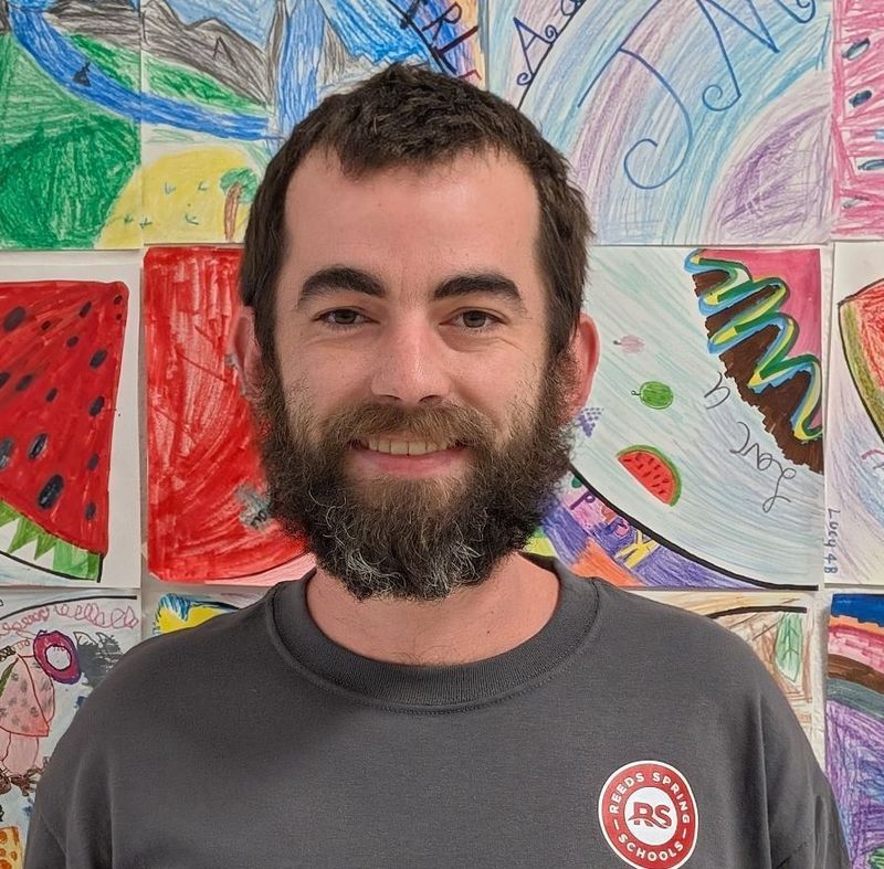 Man with beard smiling at camera