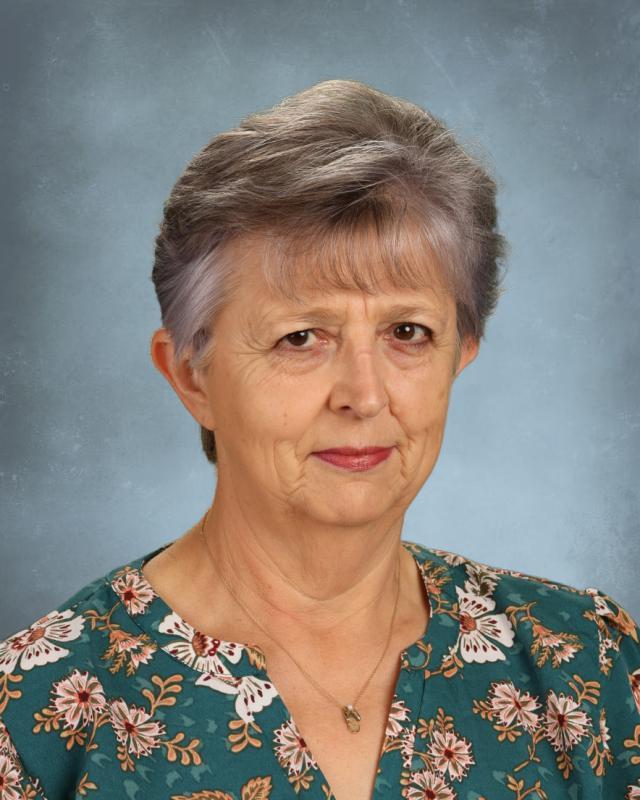 woman in flowery shirt smiling
