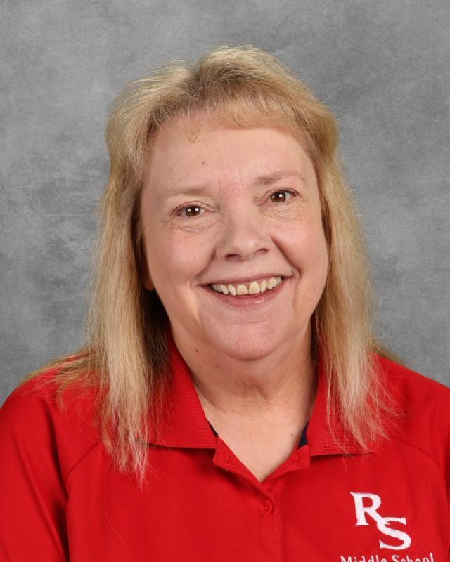 woman in red polo smiling