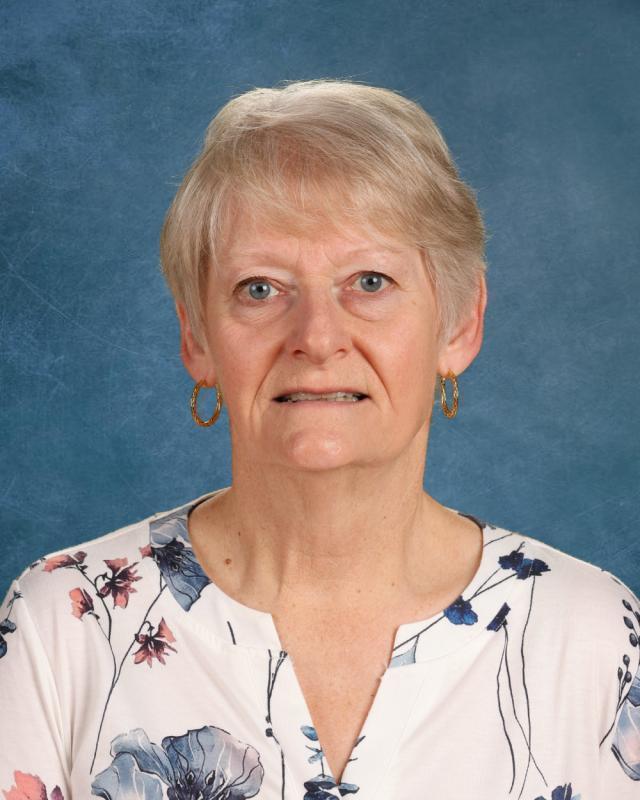woman in white shirt with flowers smiling