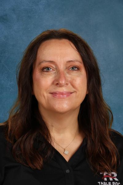 woman in black polo smiling