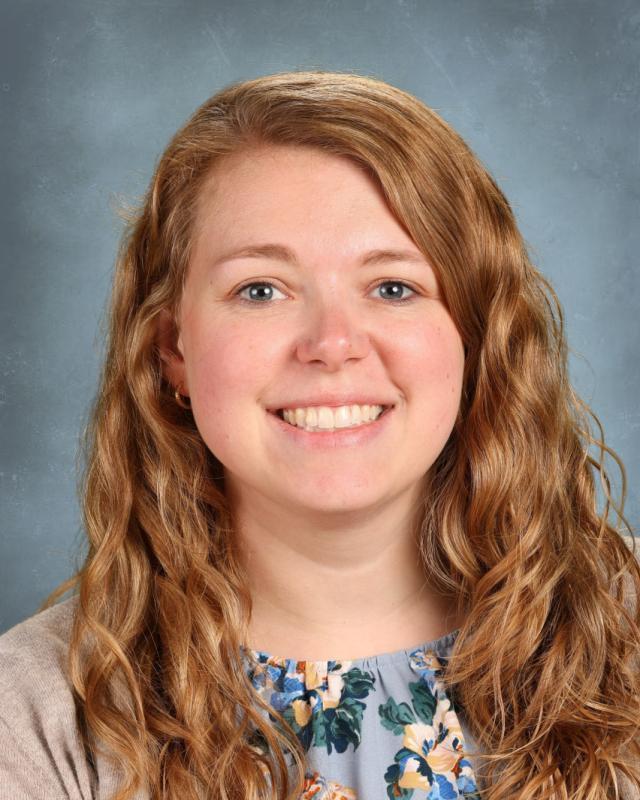 woman in blue flowery shirt smiling