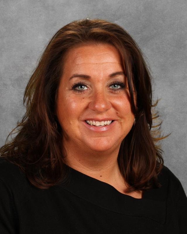 woman in black polo smiling