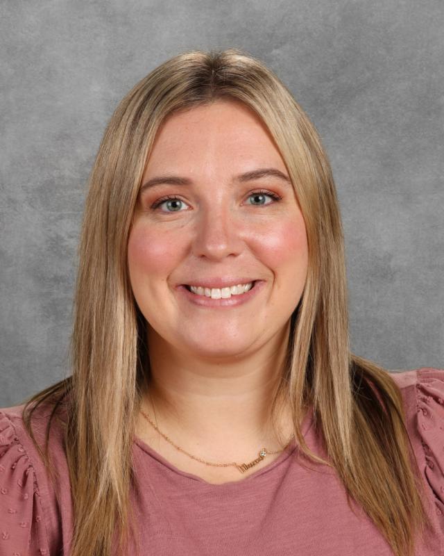 woman in pink shirt with blond hair