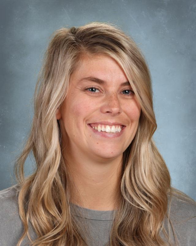woman with blond hair and gray shirt