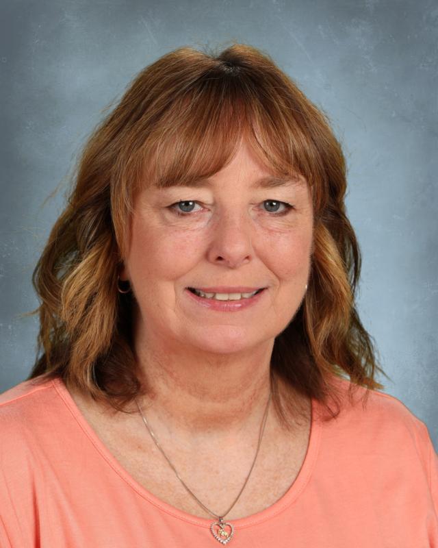 woman with brown hair and orange shirt