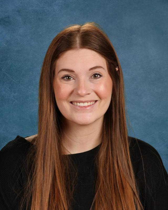 woman with long brown hair and black shirt