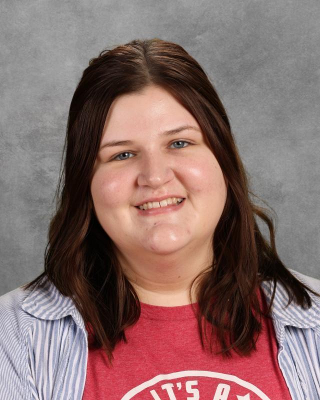 woman in red shirt with brown hair