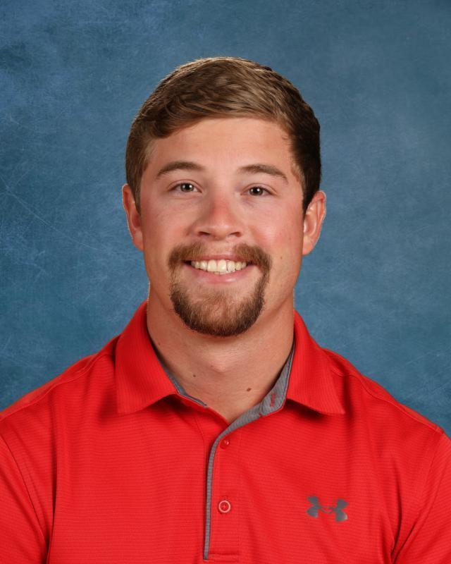 man with brown hair and red shirt