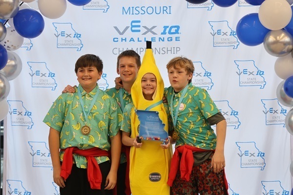 team posing for photo with trophy