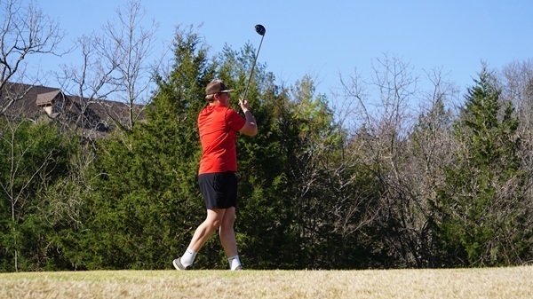Evan Metcalfe watches tee shot