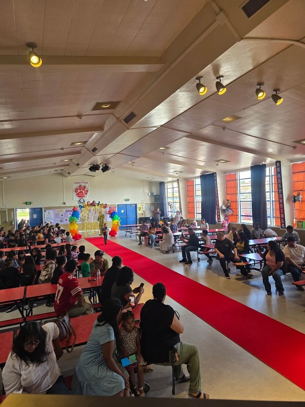 KCES promotion in cafeteria with parents and friends