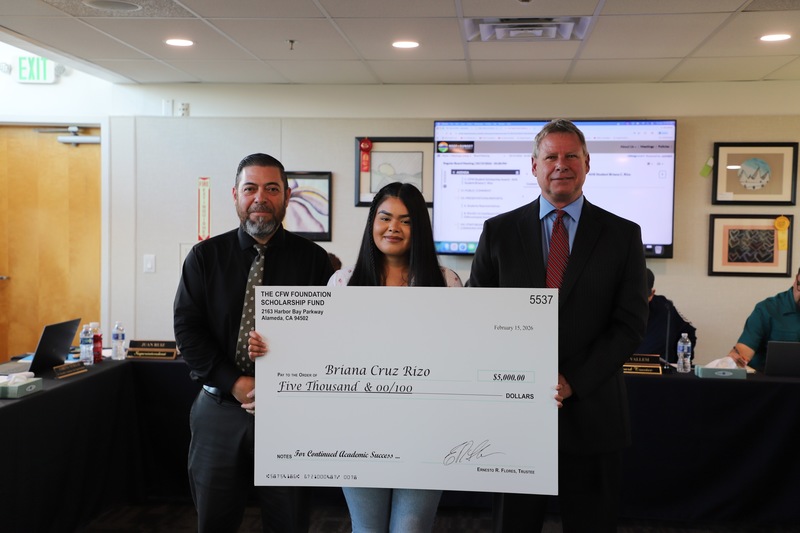 AHS student scholarship recipient with presenter and superintendent