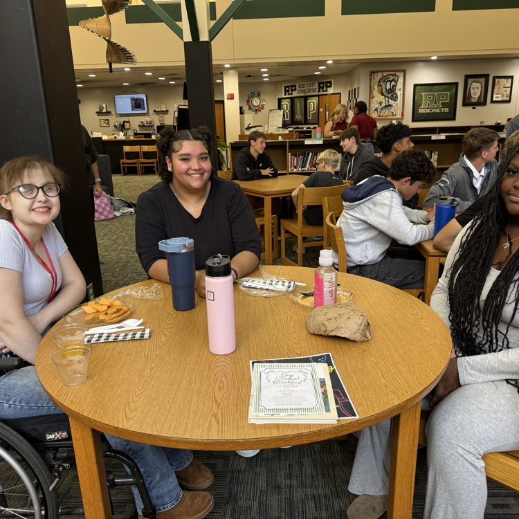students sitting at a table. 