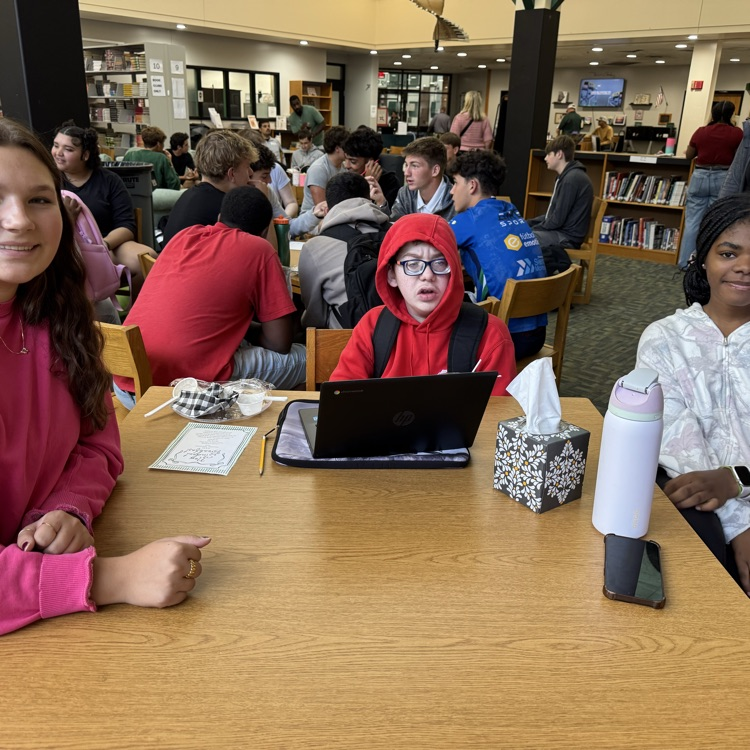 students sitting at a table. 