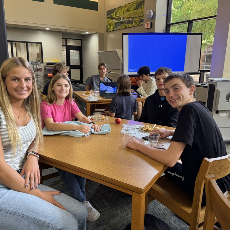students sitting at a table. 