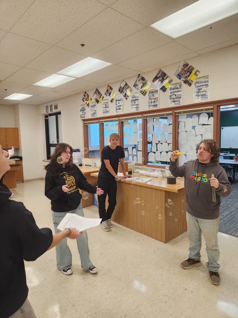Students working in lab groups with bubbles. 