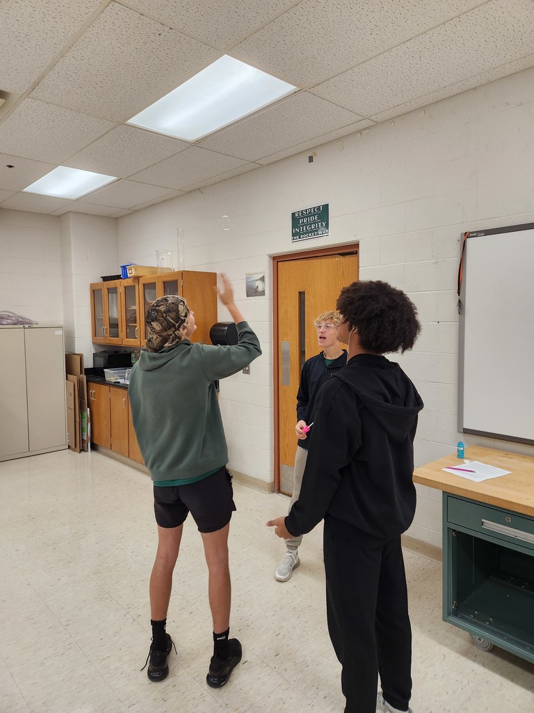 Students working in lab groups with bubbles. 