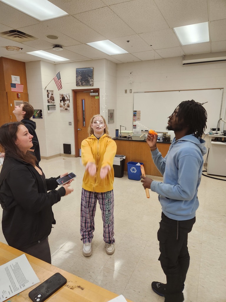 Students working in lab groups with bubbles. 