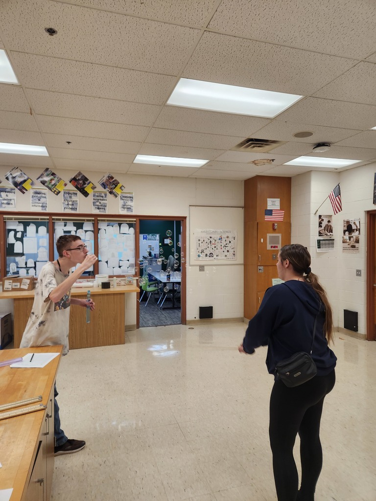 Students working in lab groups with bubbles. 