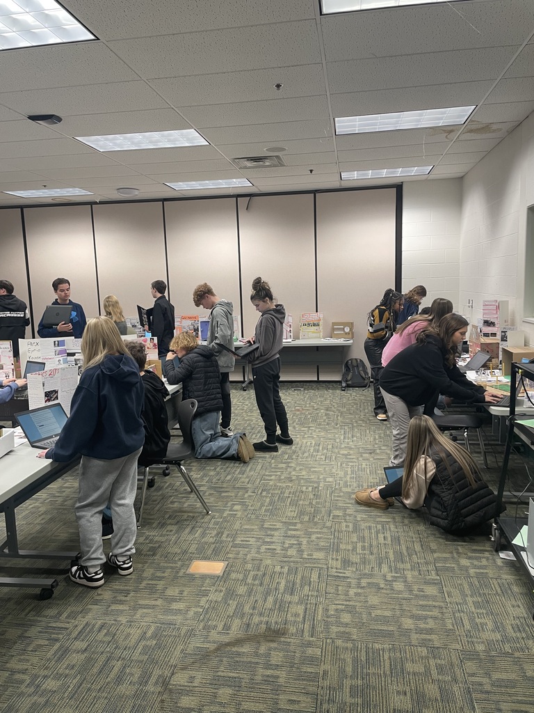 Students answering questions from other classmate's projects.