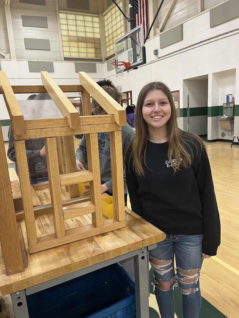 students assembling materials using a hammer and nails
