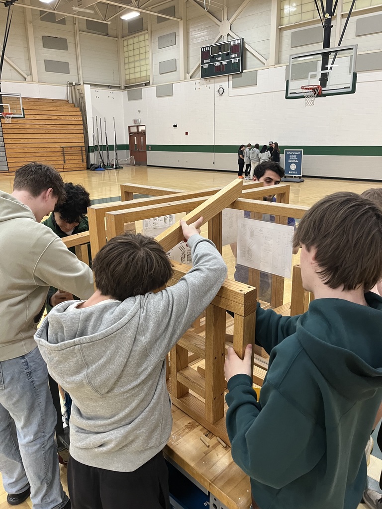 students lining lumber to assembly