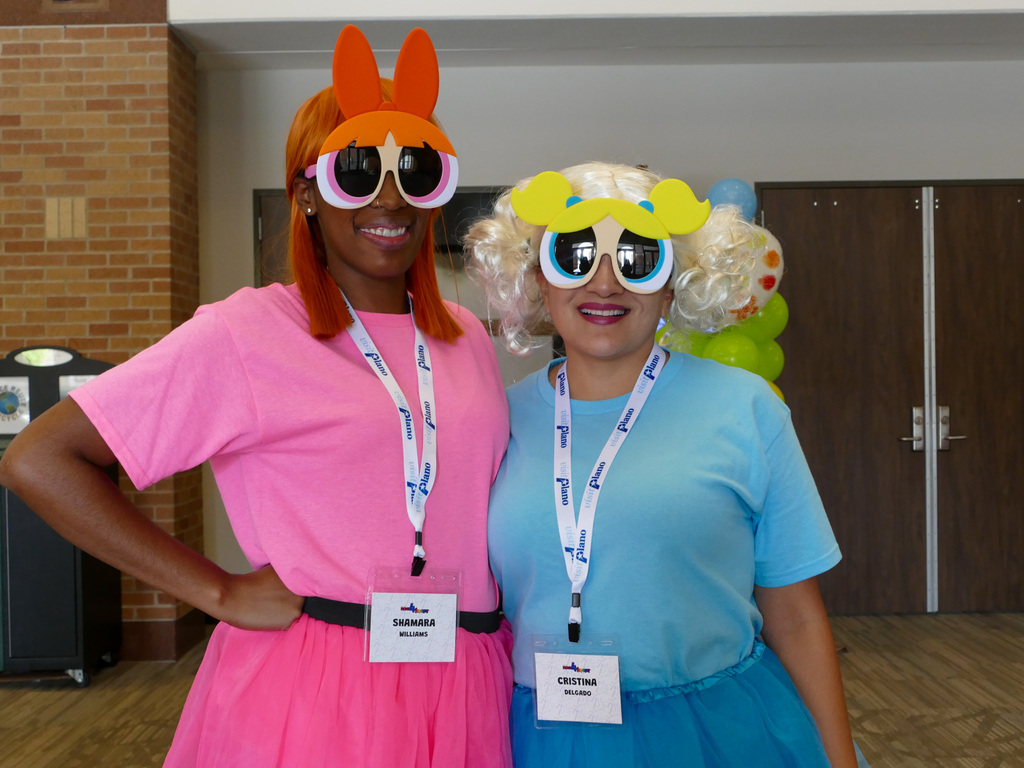 Two ladies dressed as the power puff girls.