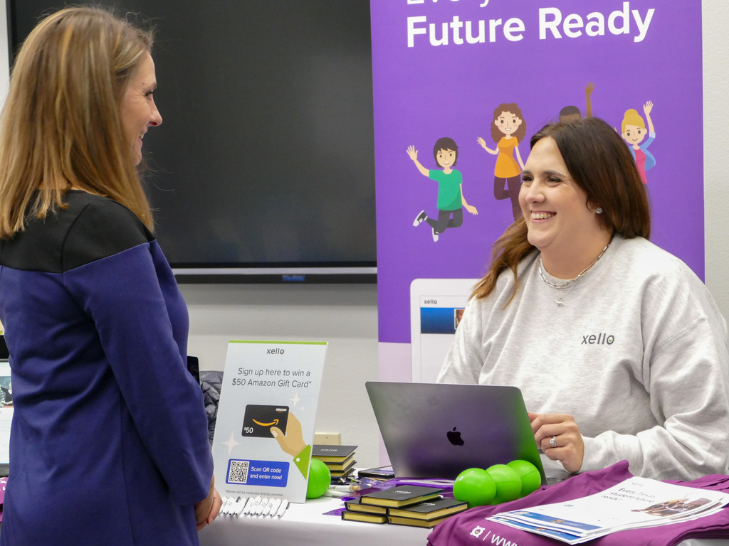 a lady talking and smiling to a customer in a friendly way.