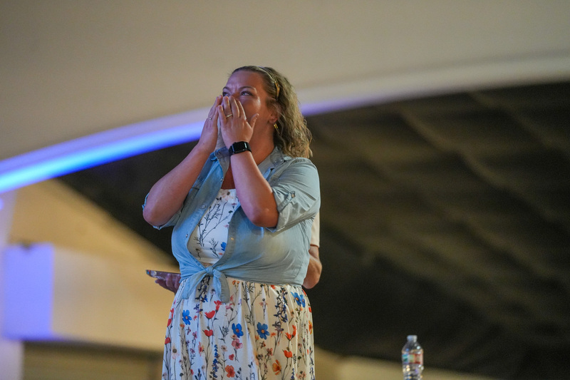 Woman proudly watching a video on the screen after winning an award.
