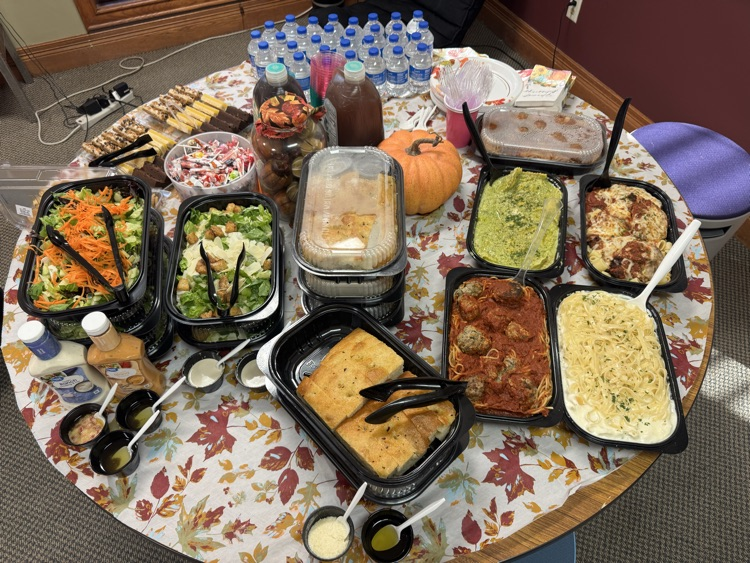 table full of pasta, bread, and salad 