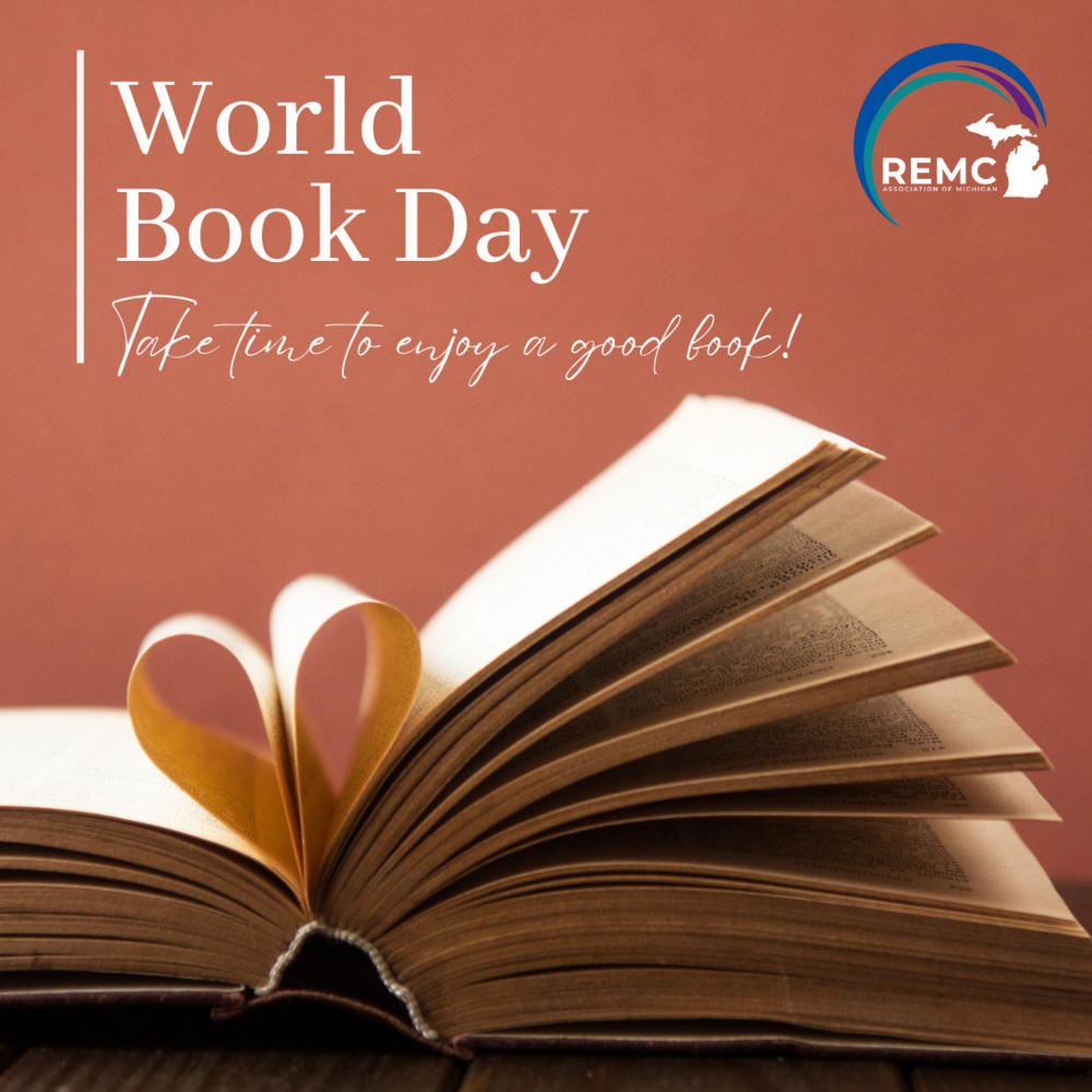 Graphic for World Book Day featuring an open book with pages folded into a heart shape. Text reads “World Book Day” and “Take time to enjoy a good book!” with the REMC Association of Michigan logo in the top right.