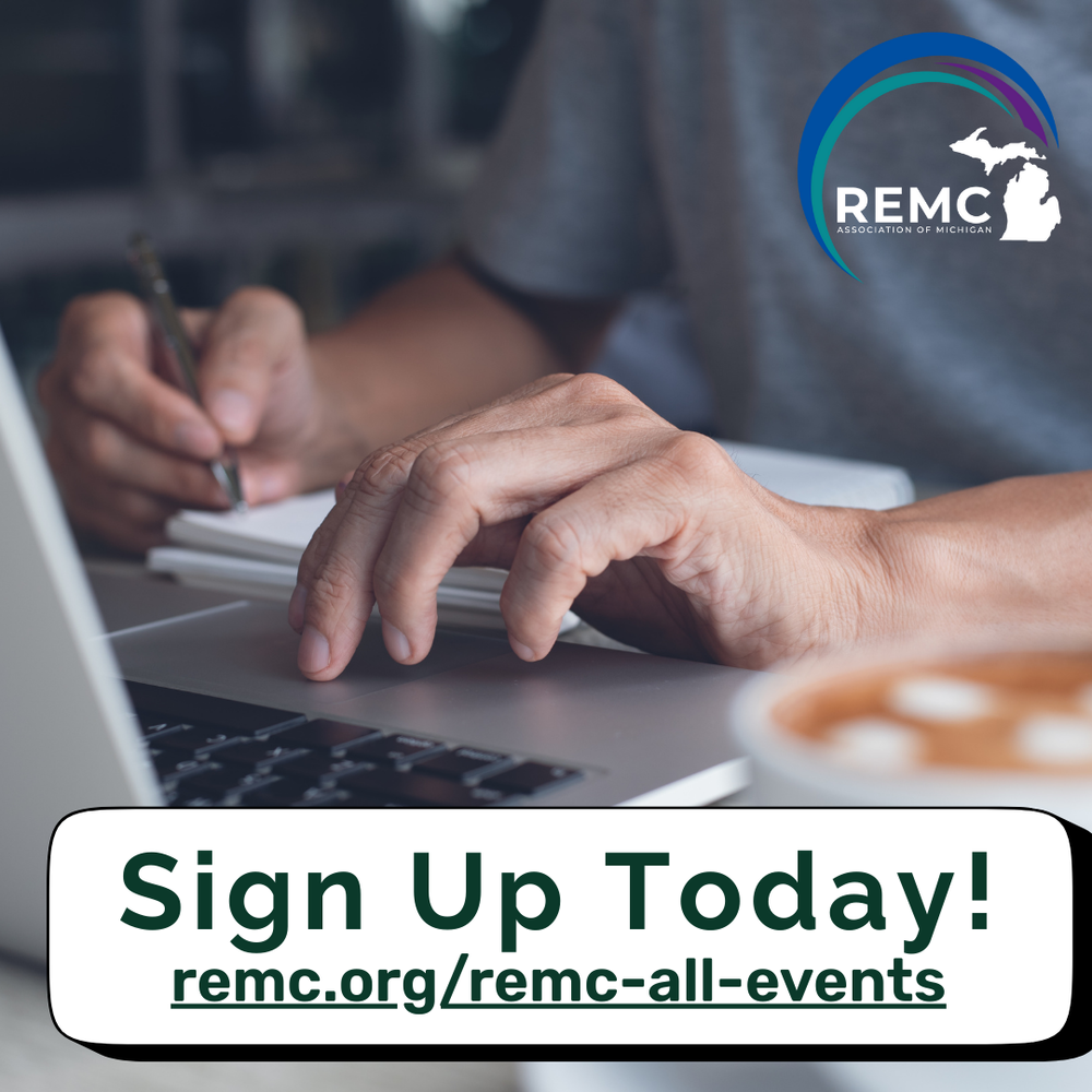 A close-up of a person’s hands working at a desk. One hand is typing on a laptop keyboard while the other holds a pen over a notebook. A cup of coffee sits on the desk. The REMC Association of Michigan logo is in the top right corner. Text at the bottom reads: “Sign Up Today! remc.org/remc-all-events."