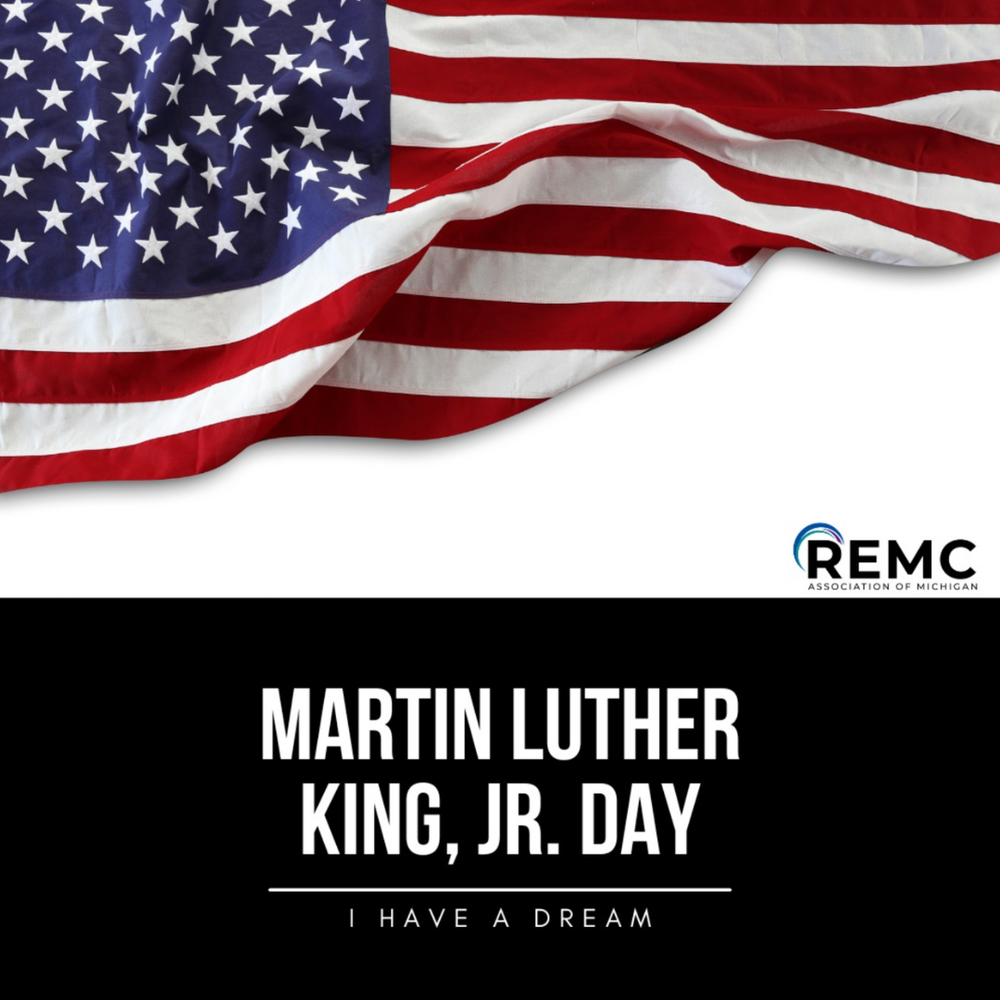 Graphic featuring a waving American flag across the top and bold text reading “Martin Luther King, Jr. Day” with the phrase “I Have a Dream” beneath it. The REMC Association of Michigan logo appears in the lower right corner.