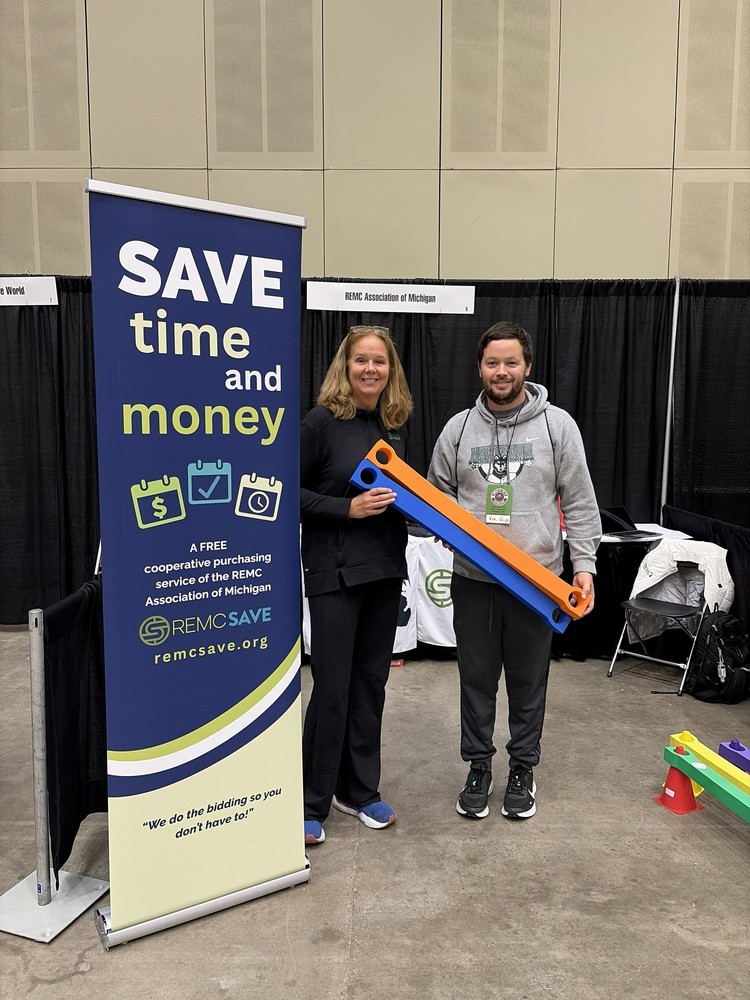 A photo of SHAPE Conference drawing winner holding their prize. Kyle Wright from Van Buren Public Schools, in a conference setting.