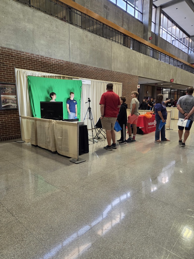 Students interacting with the green screen