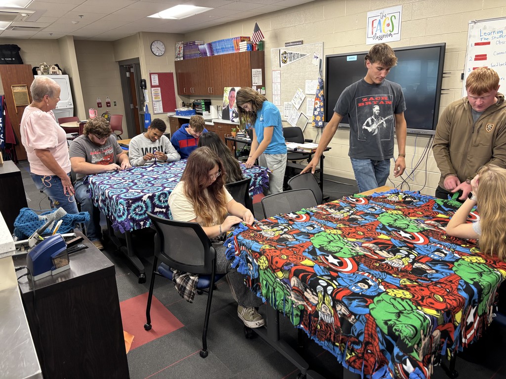 FACS Community Connections class helping tie Cuddle blankets. 