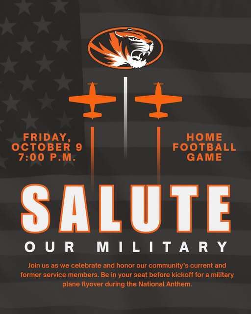 An promotional graphic for a "Salute Our Military" home football game scheduled for Friday, October 9 at 7:00 P.M. The background features a dark, stylized American flag with stars and stripes. At the top center is an orange and black tiger logo, positioned above two orange military airplane silhouettes.