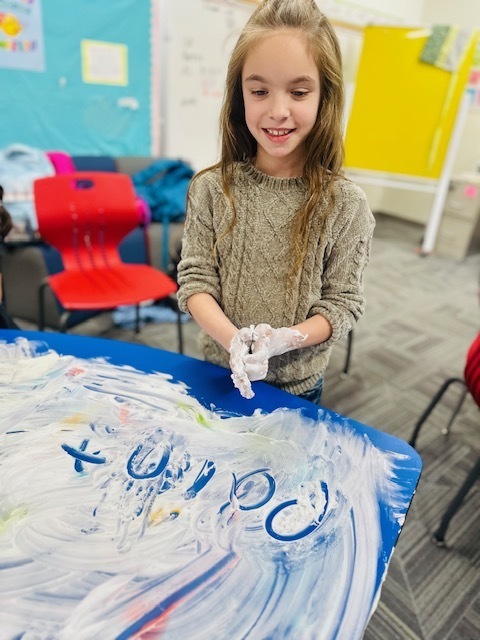 2nd graders writing words using shaving cream