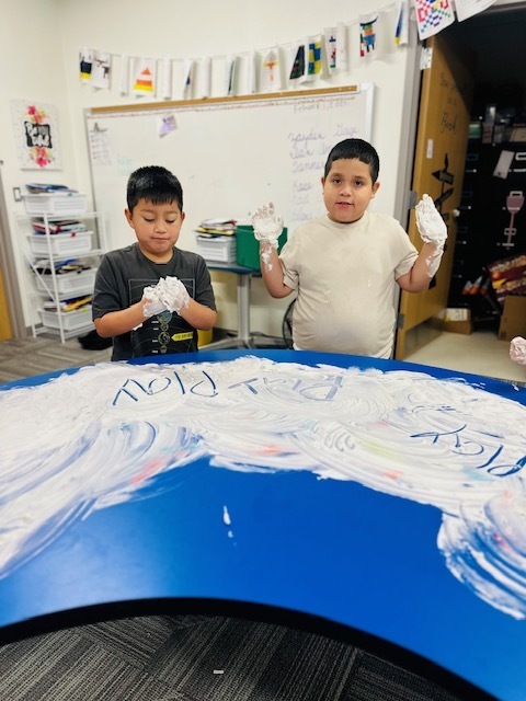 2nd graders writing words using shaving cream