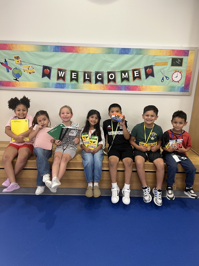 Elementary students with school supplies